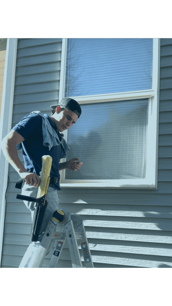 Alta Cleaning technician squeegeeing an exterior window in Utah