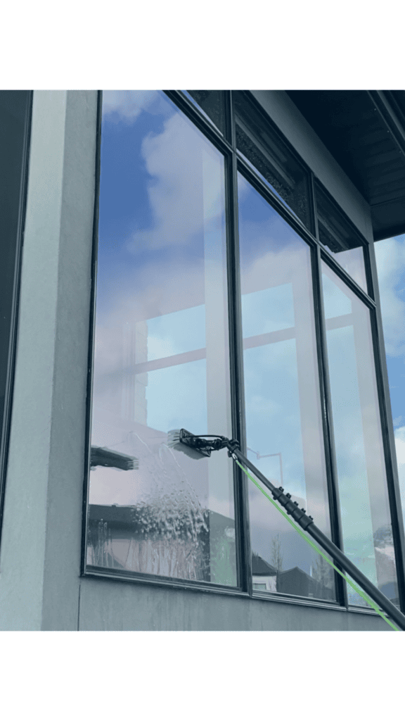 Water-fed pole system cleaning a tall exterior window in Utah